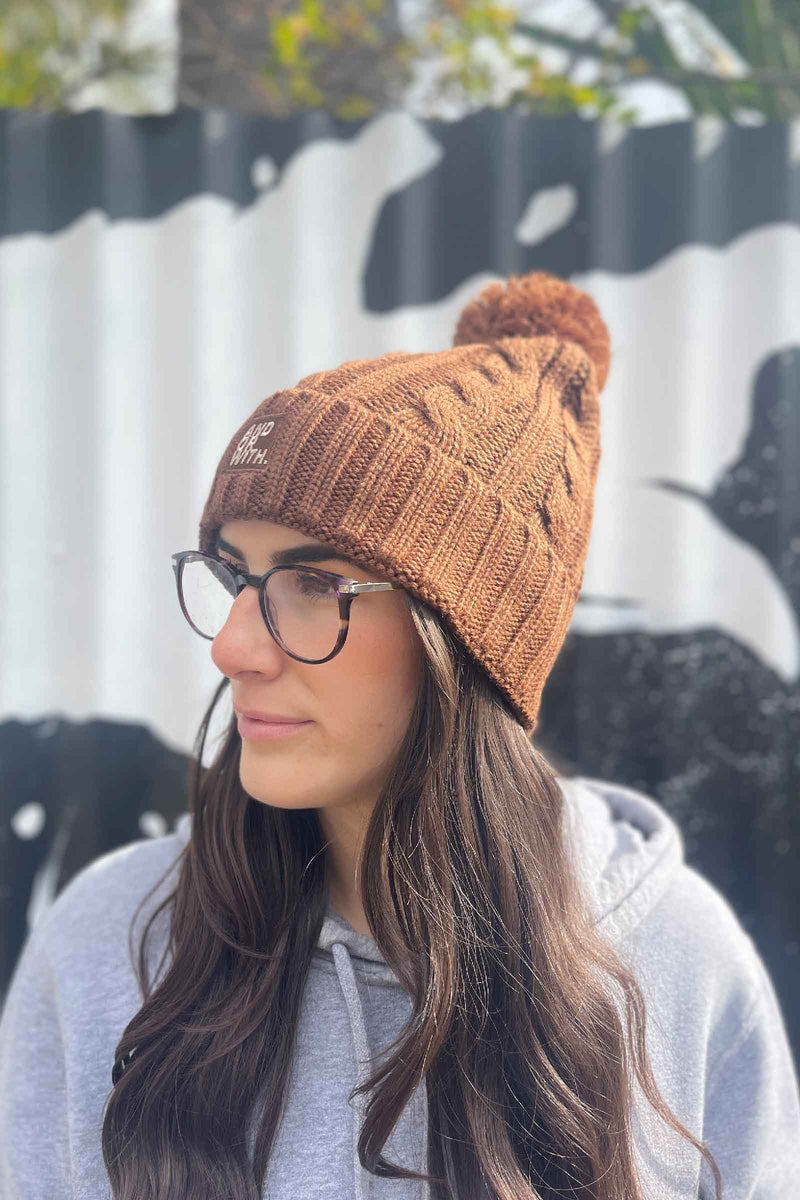 unisex-brown-cable-knit-beanie-andorwith-surf-skate-wear